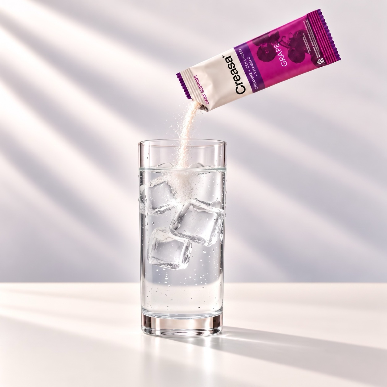 Creasa+ grape powder pouring into a glass of iced water